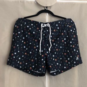 Penguin party swim trunks